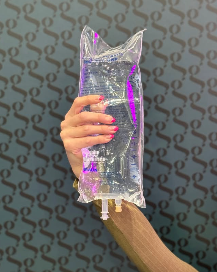 IV Therapy Landing Page 3 a hand holding a bag of liquid
