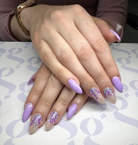 a close up of a hand with painted nails